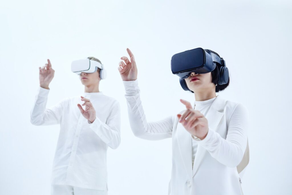 Man and Woman in White Long Sleeves Wearing Virtual Reality Headsets